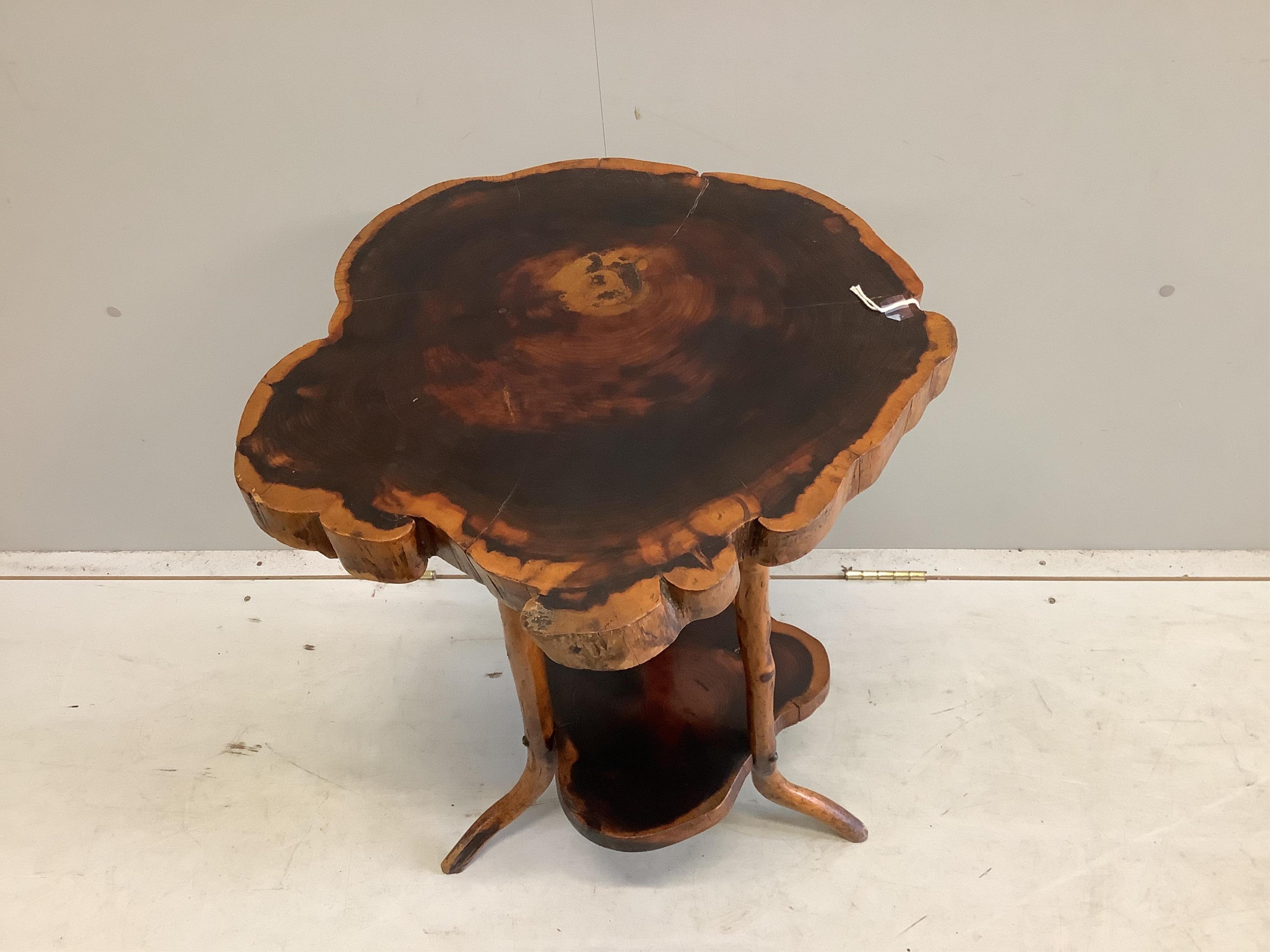 A rustic tree section two tier occasional table, width 52cm, height 73cm. Condition - fair